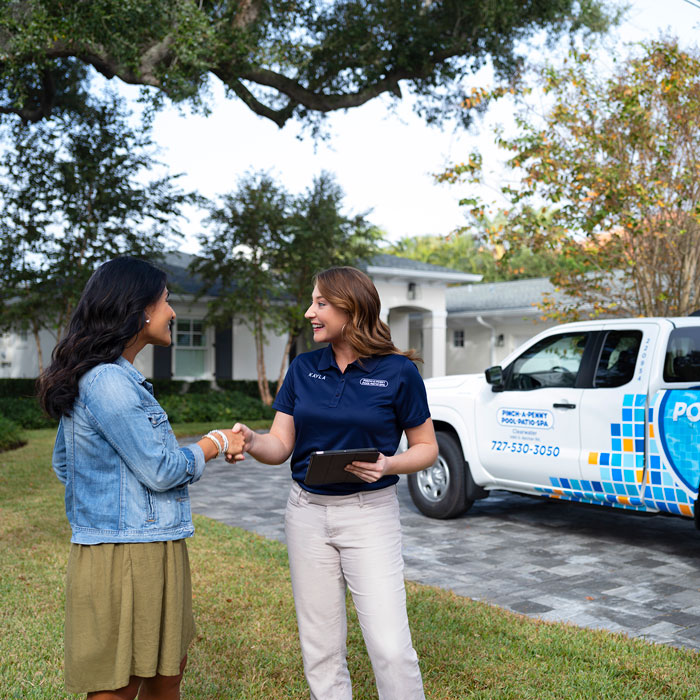A Pinch A Penny specialist and a customer shake hands in front of her house